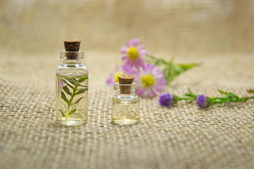 Essential oil vials with fresh flowers